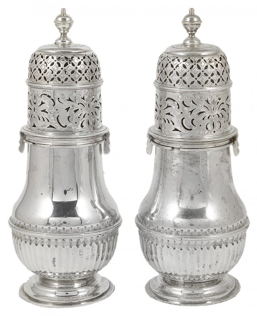 A PAIR OF EDWARDIAN SILVER CASTERS, NATHAN & HAYES OF: A PAIR OF EDWARDIAN SILVER CASTERS, NATHAN & HAYES OF BIRMINGHAM, CHESTER 1904 in early 18th century style, baluster, each with a band of fluting below the applied girdle, each bayonet fitting cover e