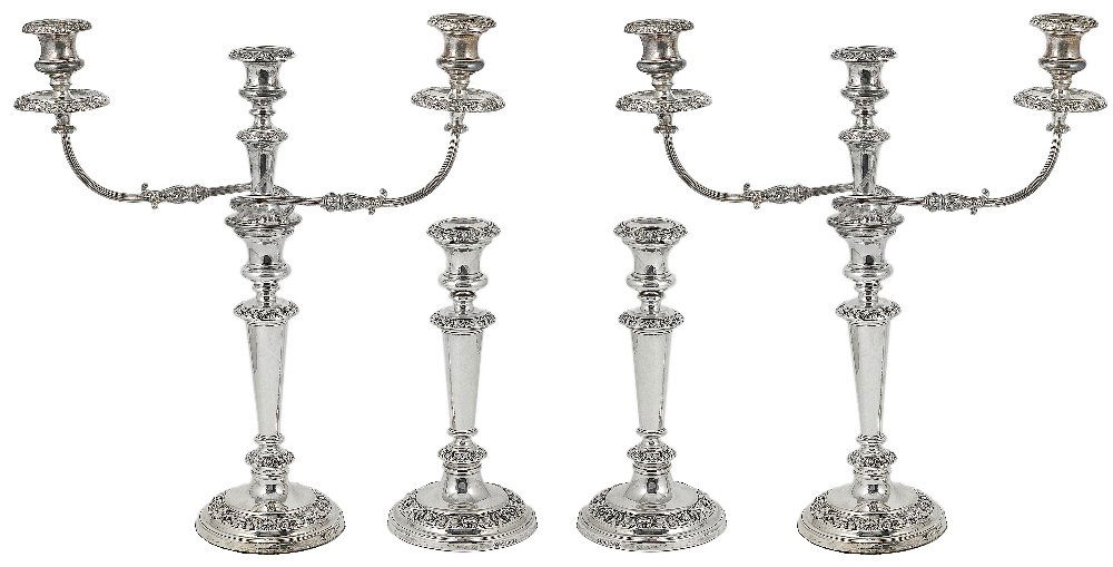 A SET OF FOUR SILVER CANDLESTICKS AND A PAIR OF: A SET OF FOUR SILVER CANDLESTICKS AND A PAIR OF SHEFFIELD PLATE CANDELABRA BRANCHES, JOHN & THOMAS SETTLE AND THEIR SUCCESSORS HENRY WILKINSON & CO., SHEFFIELD, 1825/37 the sticks with stamped foliate