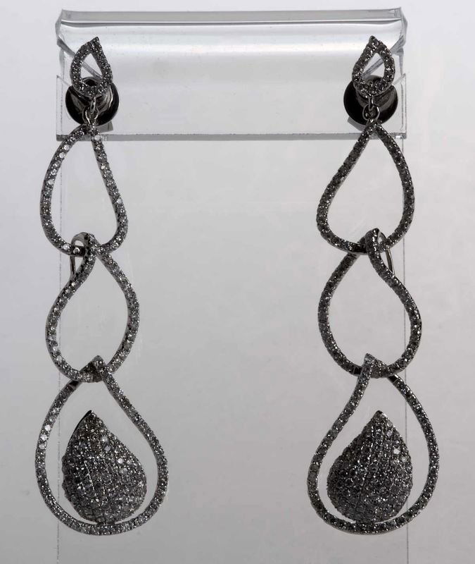 Very elegant earrings as plugs, 750'-white gold (18: Very elegant earrings as plugs, 750'-white gold (18K WG), occupies three interlocking rings with diamonds, the lower ring adorned with a big spruce with brilliant drops Mikropavée. Si diamonds of tot