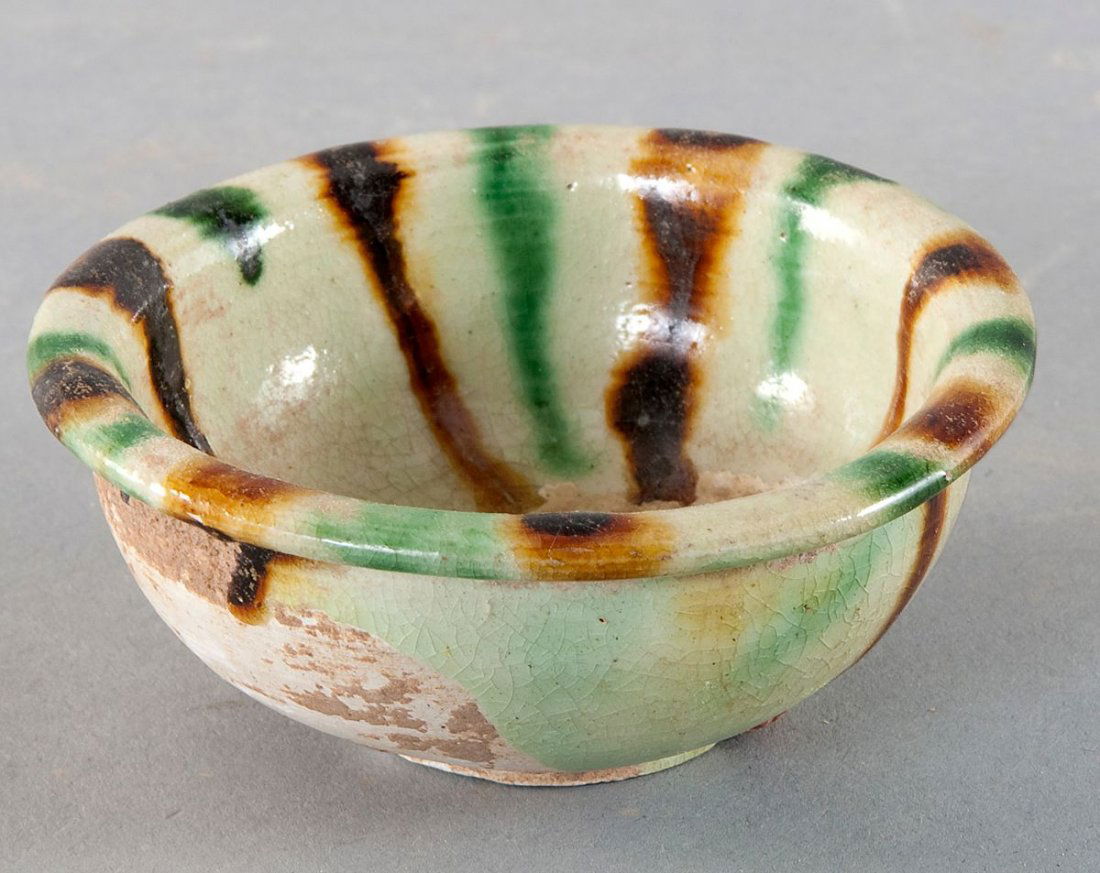 Drinking cup, China, Tang Dynasty: Drinking cup, China, Tang Dynasty (619-907 AD.), Tang Sancai, bright earthenware with beige / brown honey / greenish three-color glaze. In the bottom partially beautiful and bright iridisence of the t