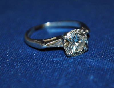 Diamond Engagement Ring: Platinum Diamond Engagement Ring Set with approximately 1.5 carat round diamond and 2 side trillion shape diamonds2.10 dwts