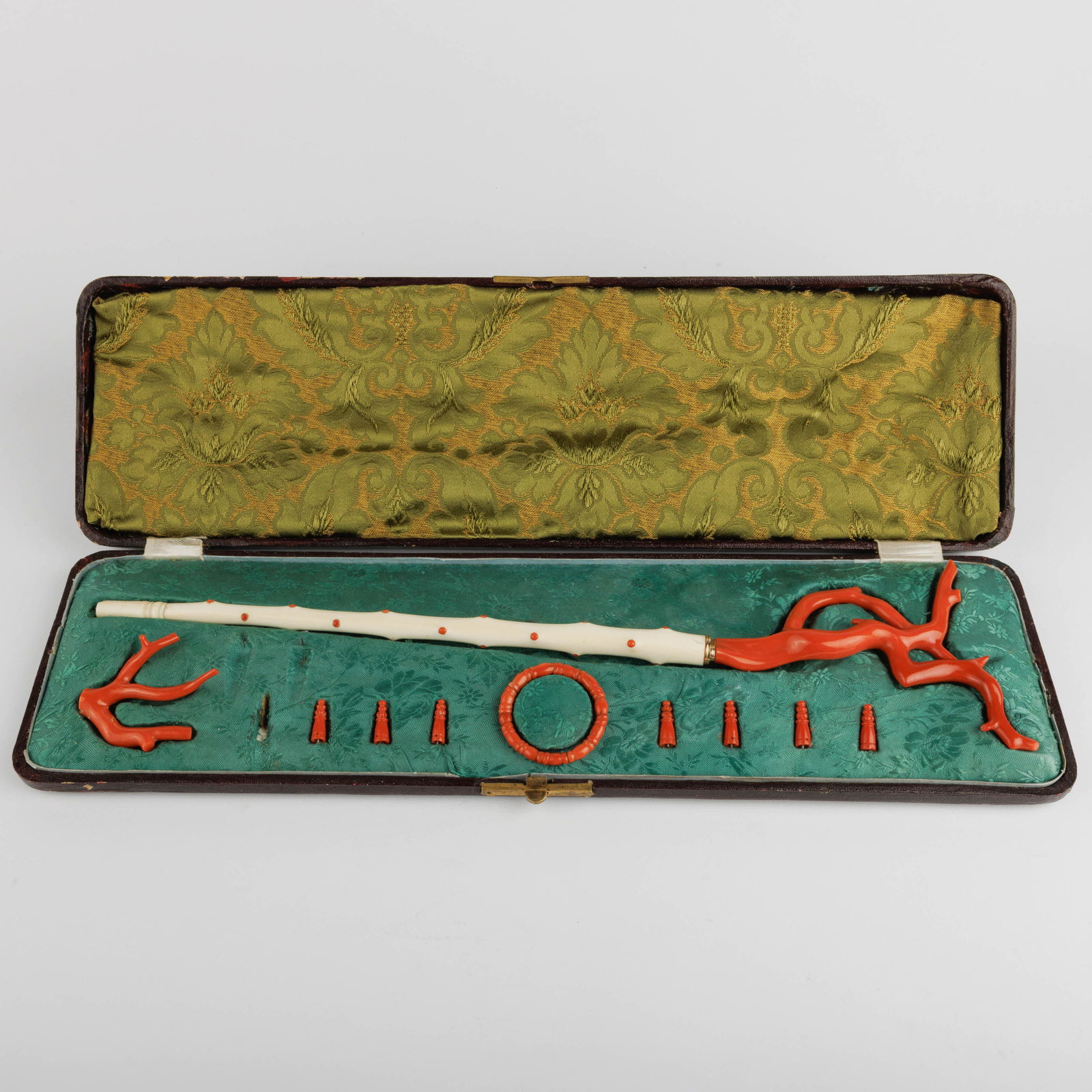 A 19th-century ivory and orange-red coral umbrella stick. in a box.
With loose pieces. (1 of 4)