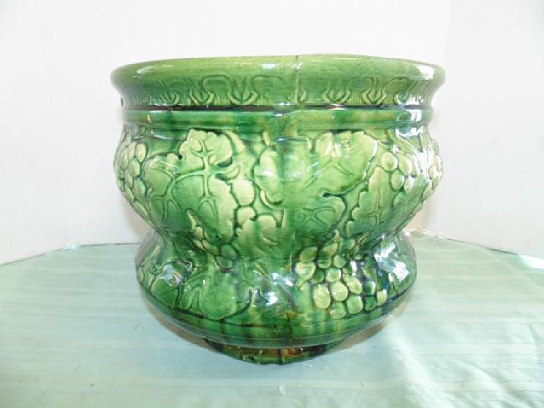 Majolica Jardinaire: Green Majolica jardinaire 11" tall. Old repair on bottom with staple.