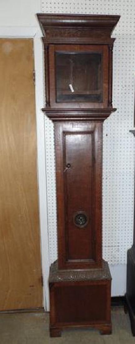 Oak Grandfather Clock: Oak Grandfather clock with bullseye glass in door. Face and works need assembly. 58822 The mechanical condition of clocks and watches is not guaranteed, nor is the disclosure of any replaced or missin