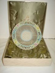 Belleek Basket Bowl in Satin Lined Box: Signed Belleek Bowl 9 1/2" diameter. Blue Branch shaped handles. Reticulated basket weave with delicate floral & Clover border. Very Good condition.