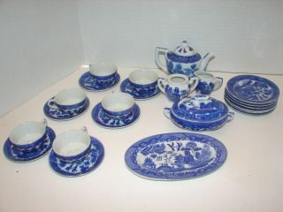 17Piece Child's Blue & White Tea Set: Cups & Saucers, Plates, Tureen, Teapot. Good Condition. Chip on one plate. Plates 4" diameter.