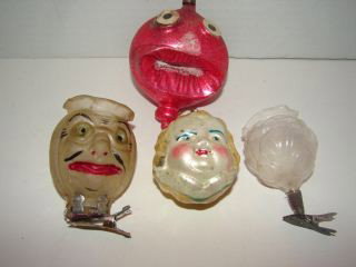 Glass Christmas Ornaments : Group ornaments including a Figural Glass Candle Holder with a Face 3", Small Glass Candle holder with flowers, Little Girl Face Ornament and a Scary Face Red Ball ornament. Very good condition.