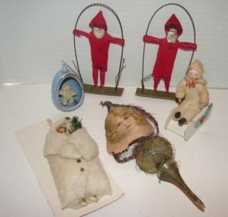 Group of Christmas Glass : Snow Baby in Blue Shell, 2 REd Cloth Santa's on Swing, Glass and Silver Thread Ornament, Cotton White Santa and a Cotton Girl on a Sled. Very good condition.