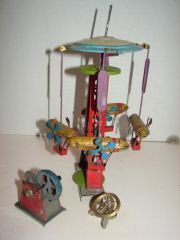 Early German Tin Litho Zeppelin Ferris Wheel Toy: German Tin litho zepplin toy appears to be missing parts. Toy measures 9 1/2" tall. Condition as is.