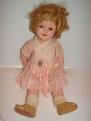 Ideal Composition Shirley Temple Doll: Doll measures 21". She has a crackled face.