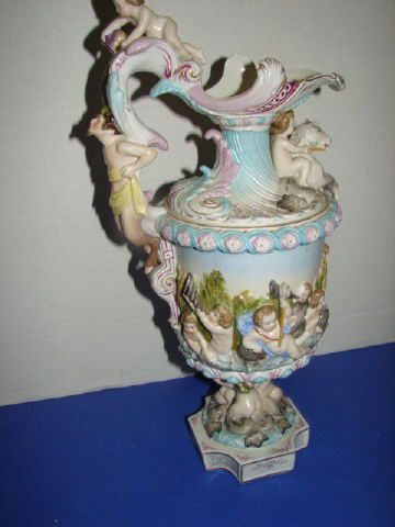 Porcelain Ewer: Crossed Blue swords mark on bottom. 15" tall. Chip on base and horse head has been repaired. Good condition.