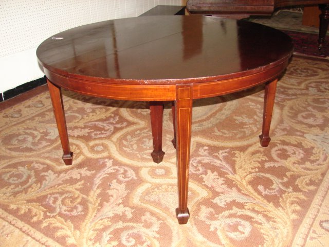 Mahogany Dining Table with Inlay: Round 54" dining table with inlay around apron and legs. Table has 6 leaves. Good condition.