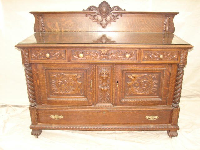 Ornate Oak Sideboard Attributed to Horner: Oak sideboard with northwind heads and carving. Backsplash with crest. Measures 61x25 1/2 x 50". Very good condition.