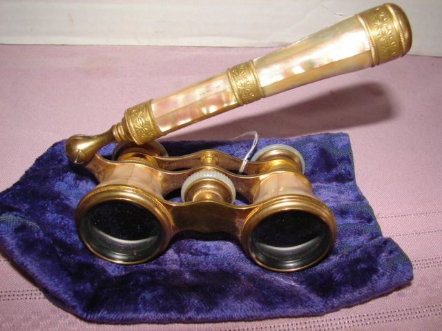 Opera Glasses: Mother of Pearl opera glasses with folding 6" hand grip. Glasses are marked Lefils Paris possibly gold plated. Velvet pouch. Very good condition.