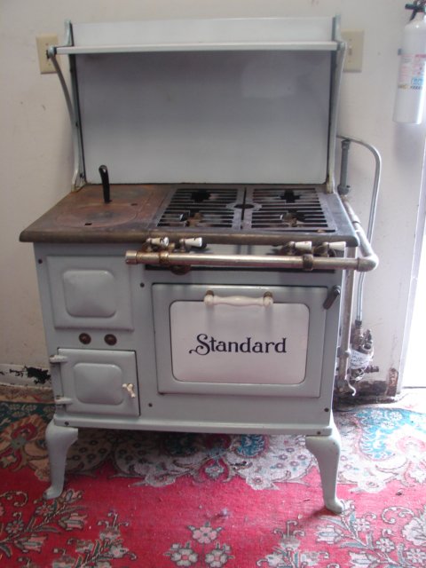 Standard Kitchen Stove: Gray and white enamel kitchen stove measures 32" wide x 52" tall to top of shelf. Very good condition.