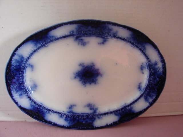 Flow Blue Platter: Flow Blue Platter measuring 16 1/2". One small chip. Platter marked Meakin. Very good condition.