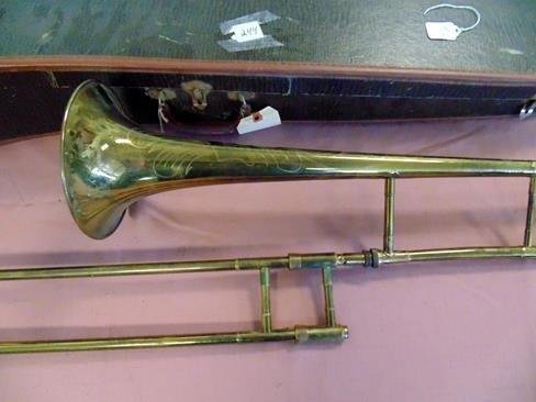 Fidelity Trombone: Fancy etched brass trombone by Fidelity. Deluxe Custom Built on label in case. Very good condition.