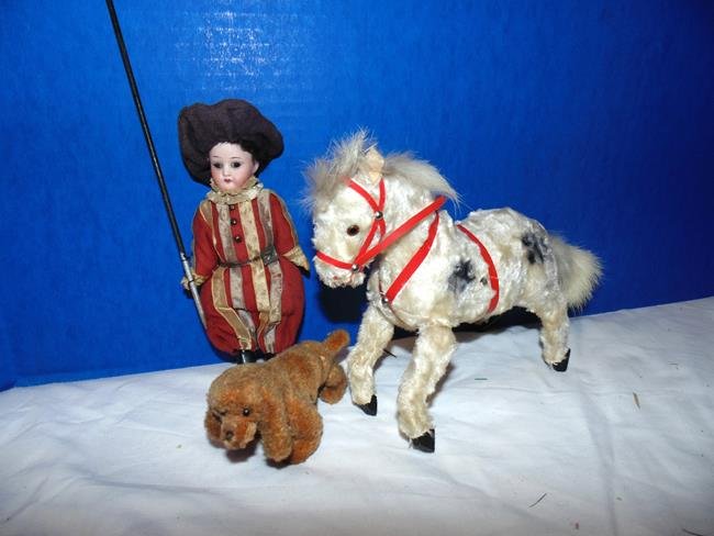 Wind Up Horse & Bisque Figure: 10" wind up horse moves front legs when wound up. Horse is working but he needs a key. 5" bisque jointed figure. Also included is a small jointed dog. Very good condition.