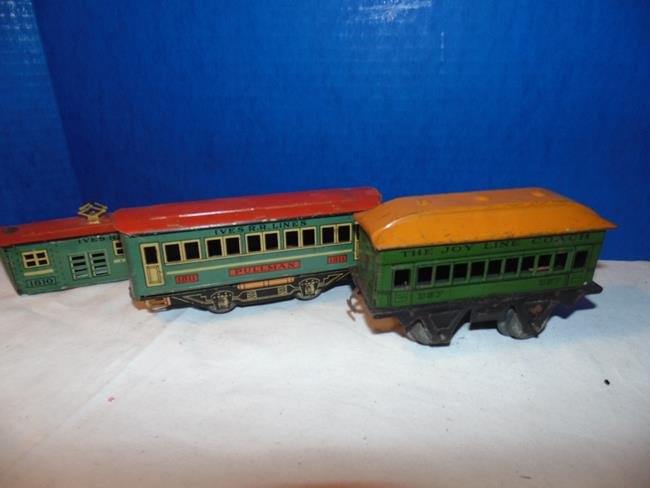 Ives Tin Litho Train Cars: Ives Pullman car good condition. Ives RR Lines tin litho car is just the body no wheels or bottom. Also in the lot is a Tin litho Joy lines car good codition.