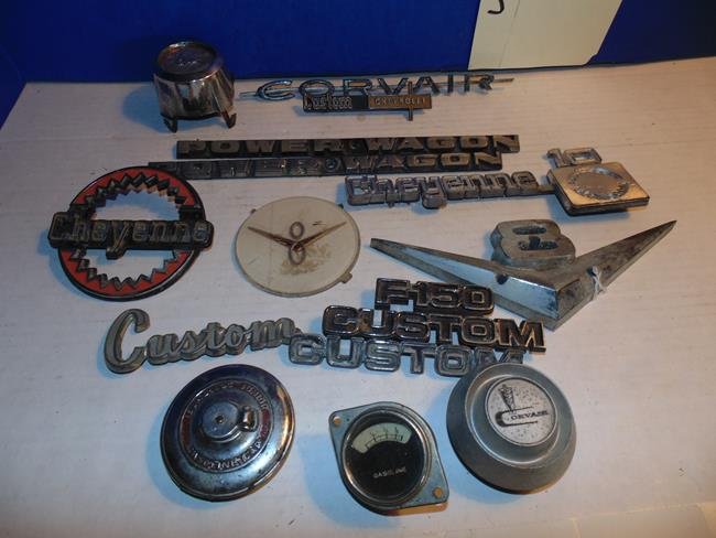 Car Elblems & Gas Caps: Group of car emblems and gas caps including Mustang, Power Wagon, Corvair, V8, F-150, Cheyenne, etc.