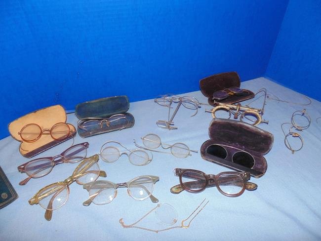 Vintage Eye Glasses: Group of vintage wire framed and plastic framed eye glasses with 2 pair for eye examination. Some partial pairs and arms.