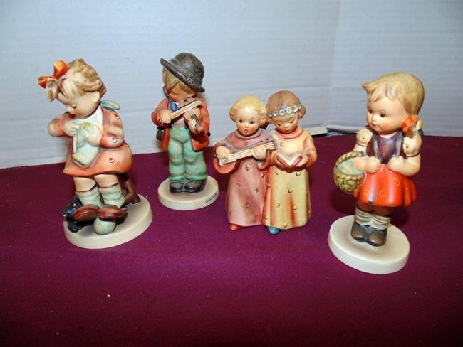 4 Hummel Figures: Mother's Helper 133 & Little School Girl 81 2/0 very good condition. Fiddler (broken umbrella end) and Angels have (wing tips broken).