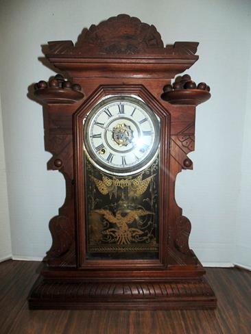Walnut Mantle Clock with Patriotic Eagle: Walnut mantle clock Made in America on dial. Flying Eagle on glass door. Pendulum no key.