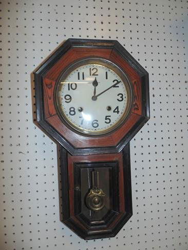 Wall Clock: Wall clock with key and pendulum.