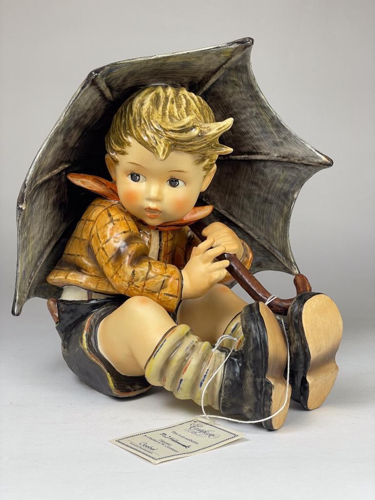 Hummel Figurine: Umbrella Boy 152 IIA TMK6 Low Estimate: 50, High Estimate: 100 This lot is from the Jack and Bette Lessard extensive Hummel Collection. Descriptions, titles, mold numbers, TMK numbers, and sizes have