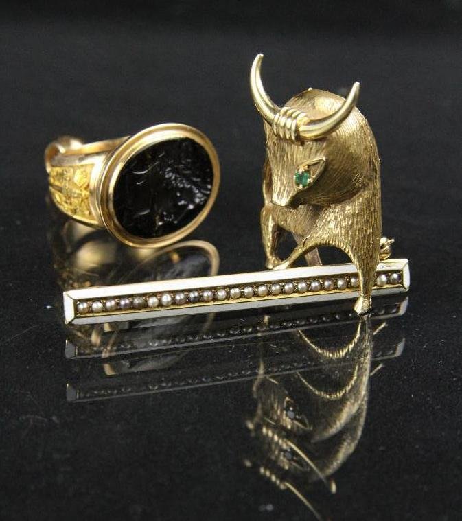 Lot of three 14k yellow gold pieces with an Intaglio: Lot of three 14k yellow gold pieces with an Intaglio ring, a bull pin, and an enamel and seed pearl bar pin, 25 grams