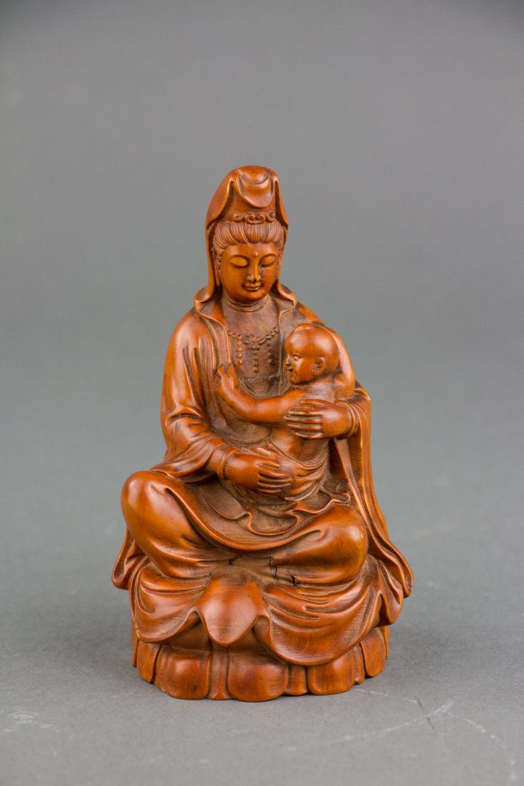 Chinese Fine Boxwood Carved Guanyin Statue: Chinese fine boxwood carved Guanyin statue; depicting Guanyin sitting on lotus pedal base, holding a boy; 12 cm x 7.5 cm, 180 grams