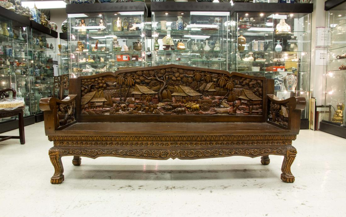 Thai Wood Sofa with Carving Decoration: Thai wood sofa; featuring carvings of Thai villages and figures in high relief; H: 88 cm, W: 60 cm, L: 178 cm
