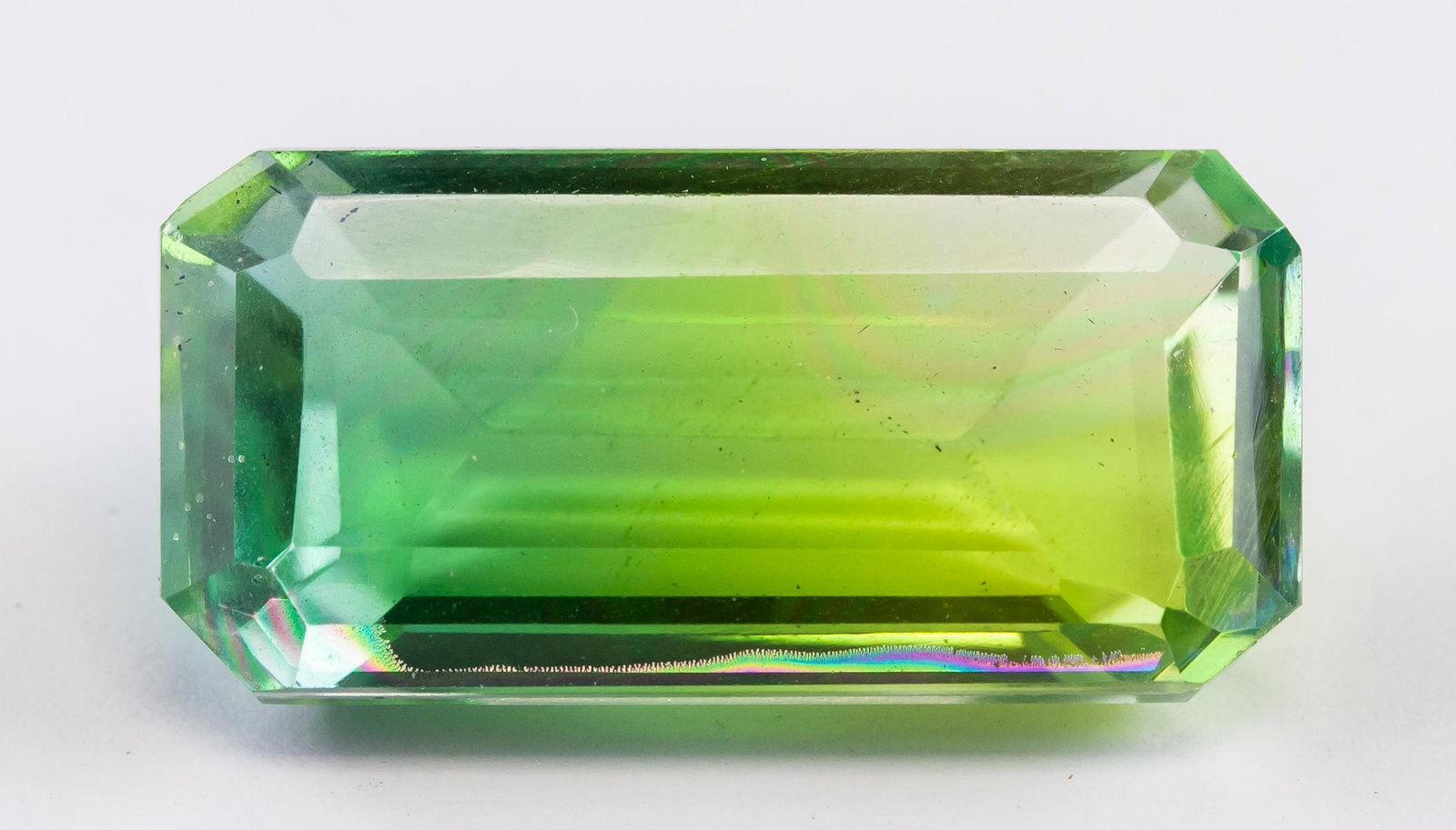 28.95ct Emerald Cut Green to Lemon Ametrine GGL: One (1) 28.95 ct emreald cut green to lemon ametrine gemstone. 27.15 x 13.36 x 10.01 mm. Accompanied with GGL certificate.