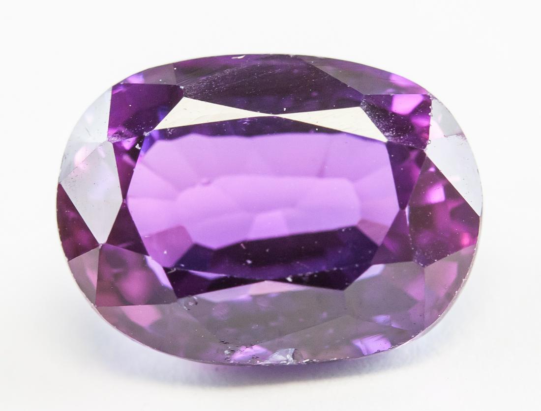 10.10ct Oval Cut Purple Natural Alexandrite GGL: One (1) 10.10 ct oval cut purple natural alexandrite gemstone. 12.35 x 10.05 x 7.61 mm. Accompanied with GGL certificate.