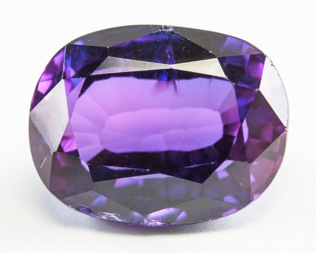 11.65ct Oval Cut Purple Natural Alexandrite GGL: One (1) 11.65 ct oval cut purple to blue natural alexandrite gemstone. Origin: India. 13.49 x 11.11 x 7.24 mm. Accompanied with GGL certificate.