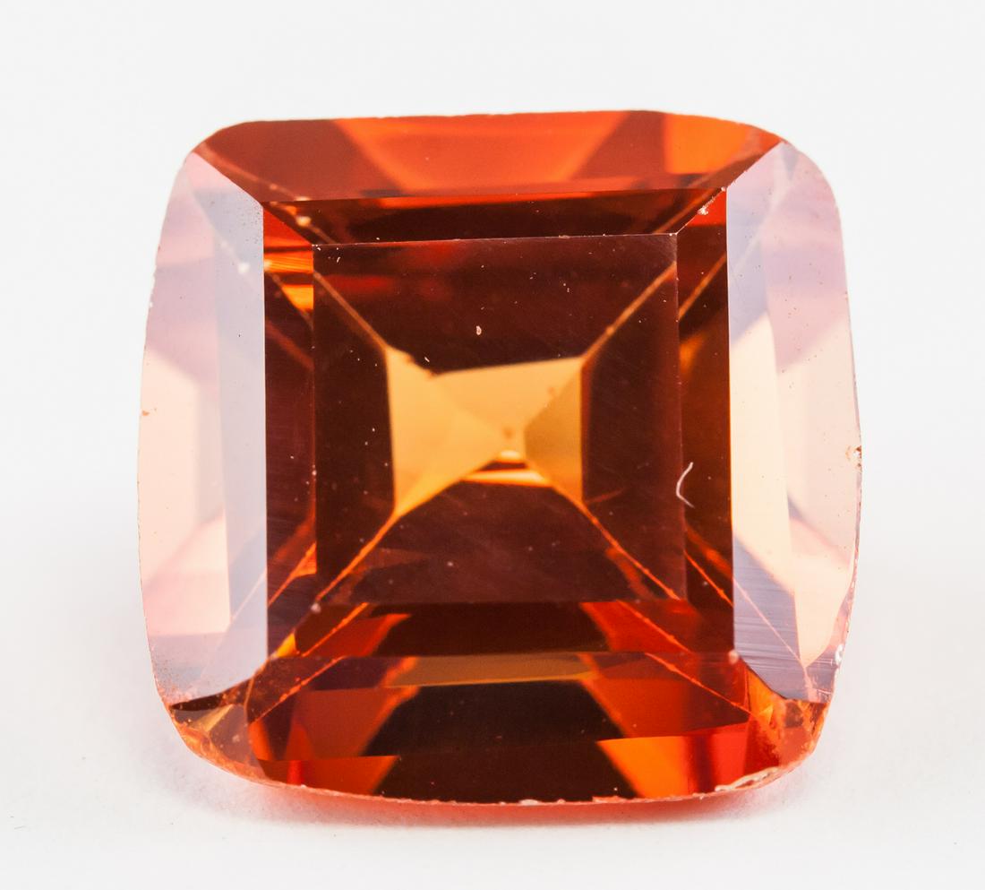 8.85ct Cushion Cut Orange-Red Natural Spinel GGL: One (1) 8.85 ct cushion cut orange-red natural spinel. Origin: Sri Lanka. 11.71 x 11.61 x 7.21 mm. Accompanied with GGL certificate.