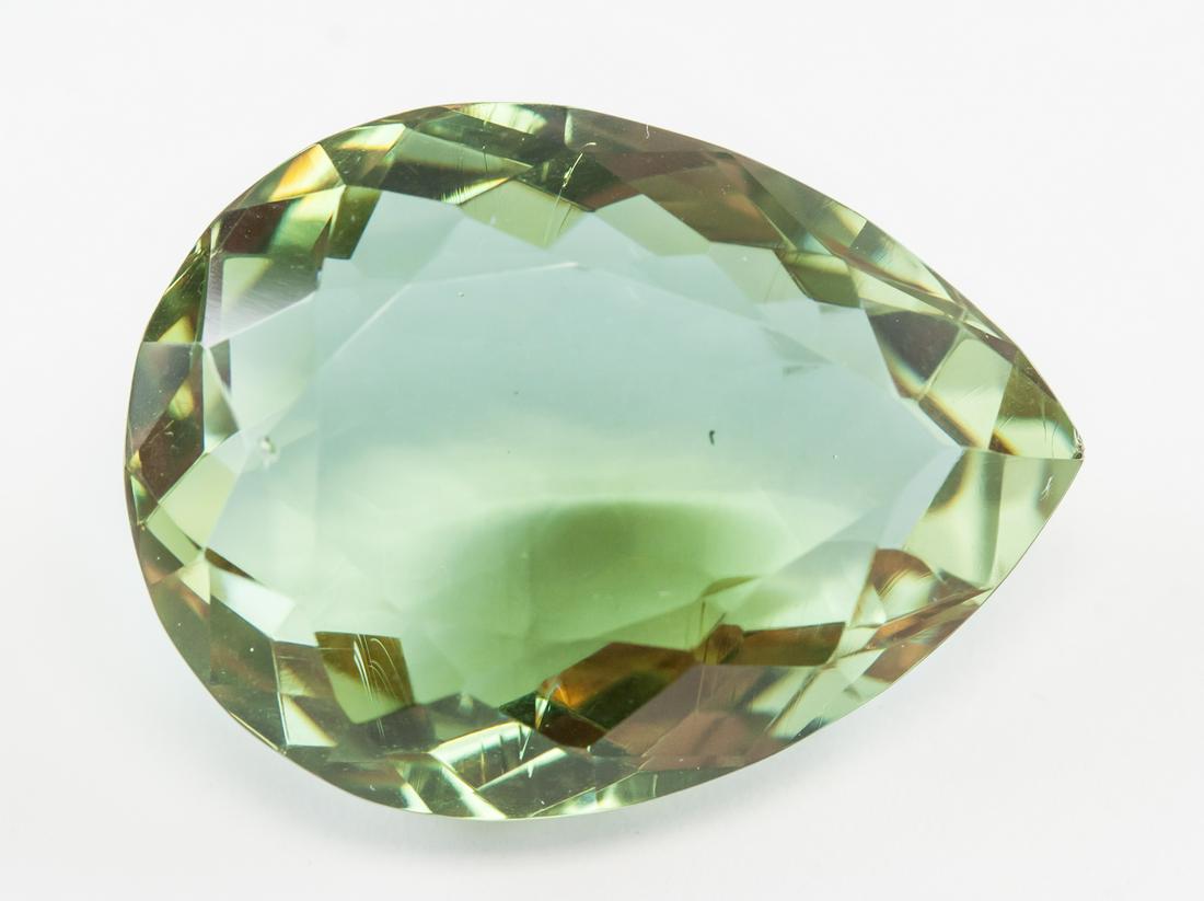 60.65ct Pear Cut Brown to Green Alexandrite GGL: One (1) 60.65 ct pear cut brown to green alexandrite. Origin: Brazil. Accompanied with GGL certificate. 30.29 x 22.46 x 14.01 mm