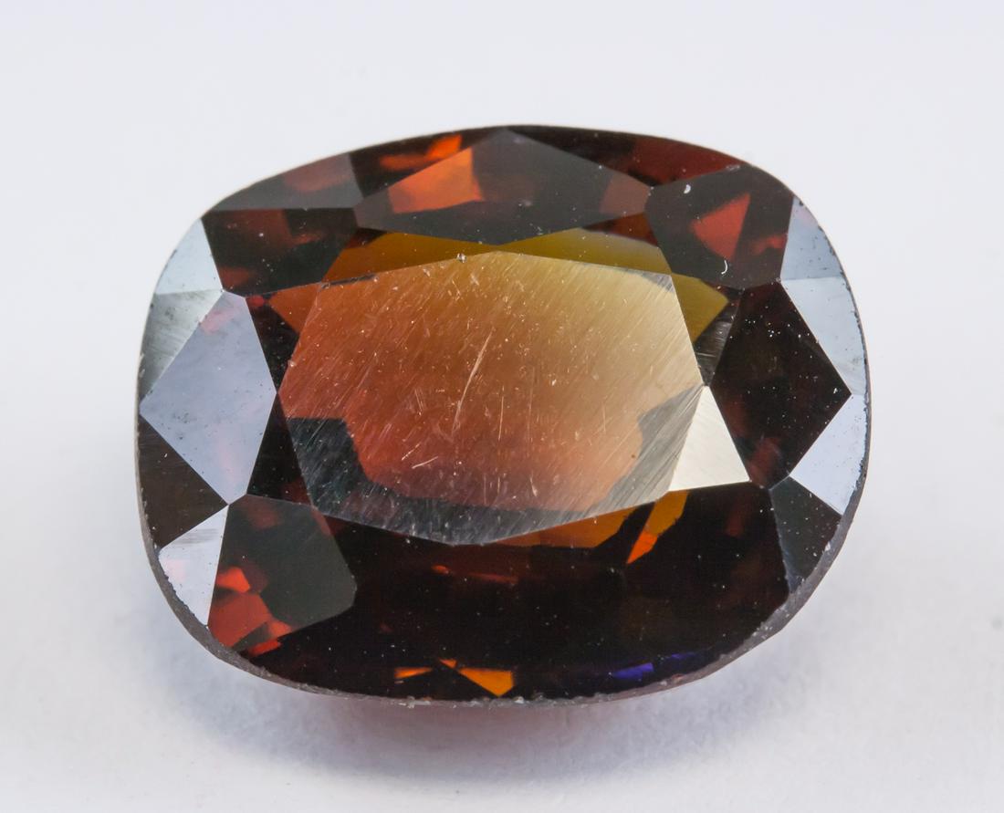 12.30ct Red Orange Cushion Cut Natural Zircon AGSL: One (1) 12.30 ct orange natural zircon gemstone. Cushion cut. Origin: Cambodia. Accompanied with AGSL Certificate. 12.31 x 10.23 x 5.98 mm