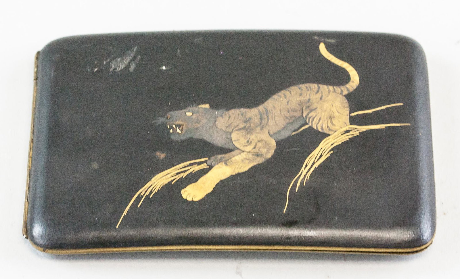 Japanese Gilt Cigarette Case: Japanese gilt cigarette case with a gilt tiger on the cover. "K24 ON STEEL" inscribed on back. Decorated on the back with two sail boats and three birds. 8 x 12 cm, 118 grams.