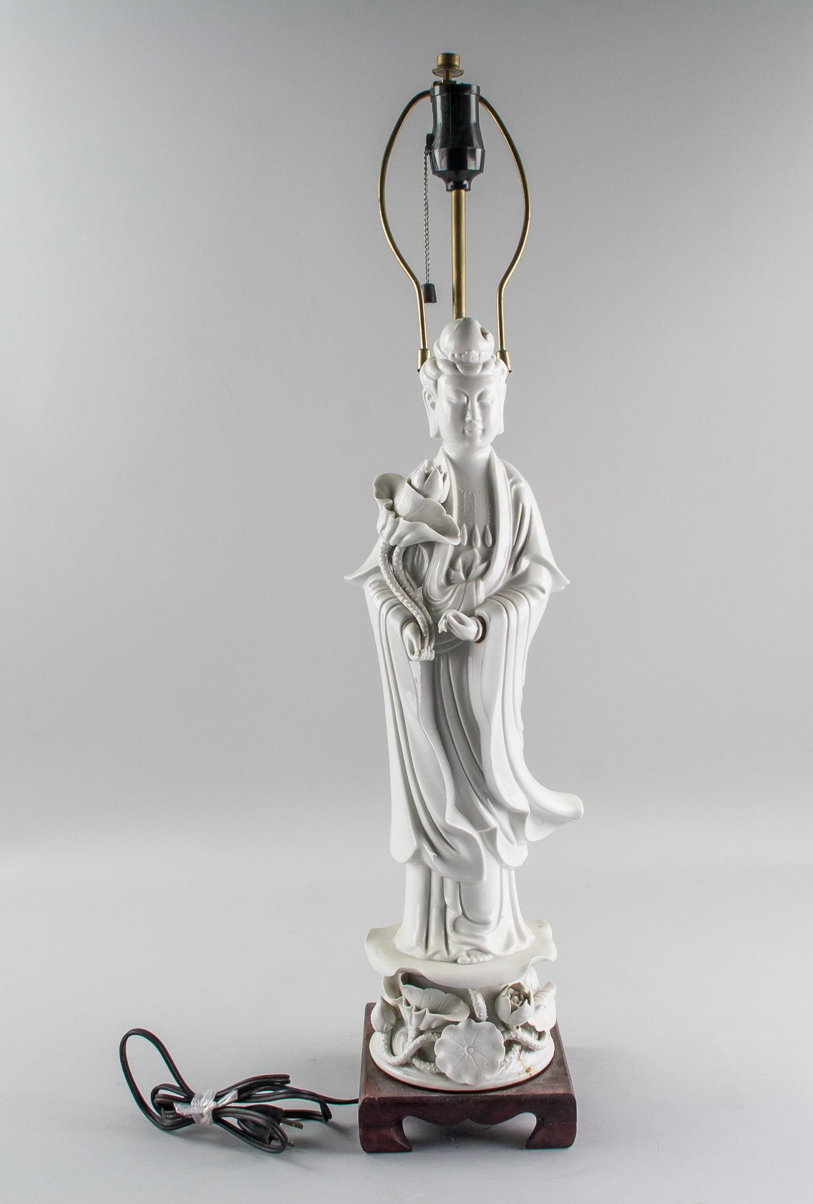 Chinese Dehua White Porcelain Guanyin Lamp: Chinese Dehua white porcelain Guanyin lamp; comprised of a standing Guanyin figure and wood base with lamp; 68 cm x 13 cm x 15 cm, 2332 grams