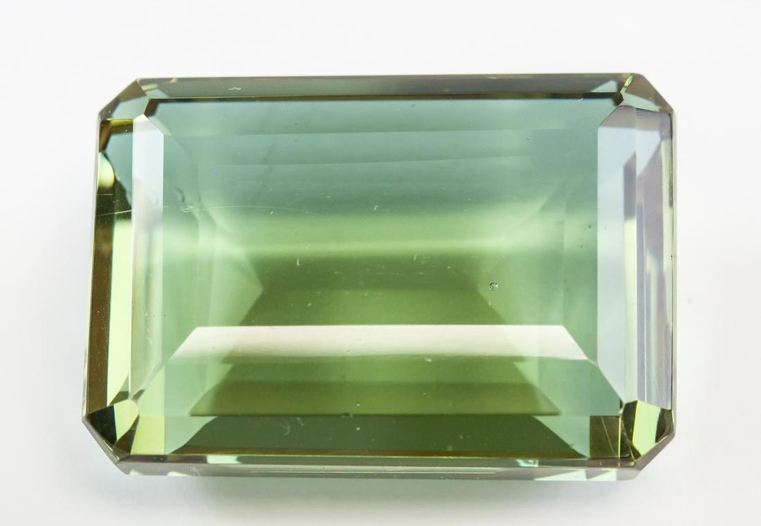 102.25ct Emerald Cut Brown-Green Alexandrite GGL: One (1) 102.25 ct emerald cut brown to green Alexandrite. Origin: Brazil. Accompanied with a GGL certificate. 31.82 x 22.16 x 14.90 mm
