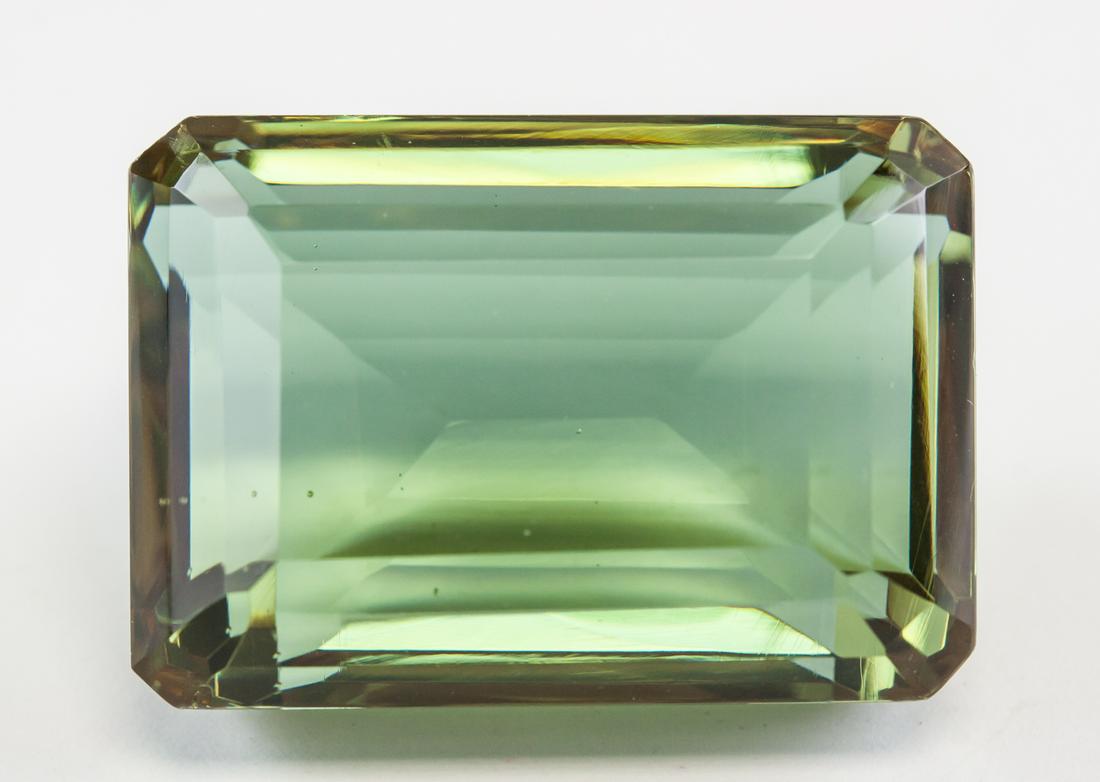 90.75ct Emerald Cut Brown to Green Alexandrite GGL: One (1) emerald cut brown to green Alexandrite. Origin: Brazil. Accompanied with a GGL certificate. 30.12 x 21.02 x 14.09 mm