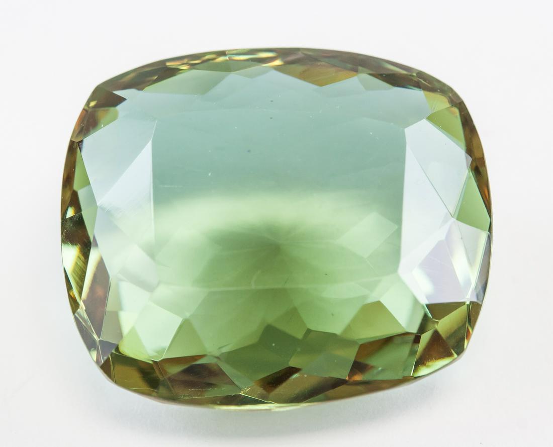 76.60ct Cushion Cut Brown to Green Alexandrite GGL: One (1) 76.60 ct cushion cut brown to green Alexandrite. Origin: Brazil. Accompanied with a GGL certificate. 30.28 x 23.79 x 14.22 mm