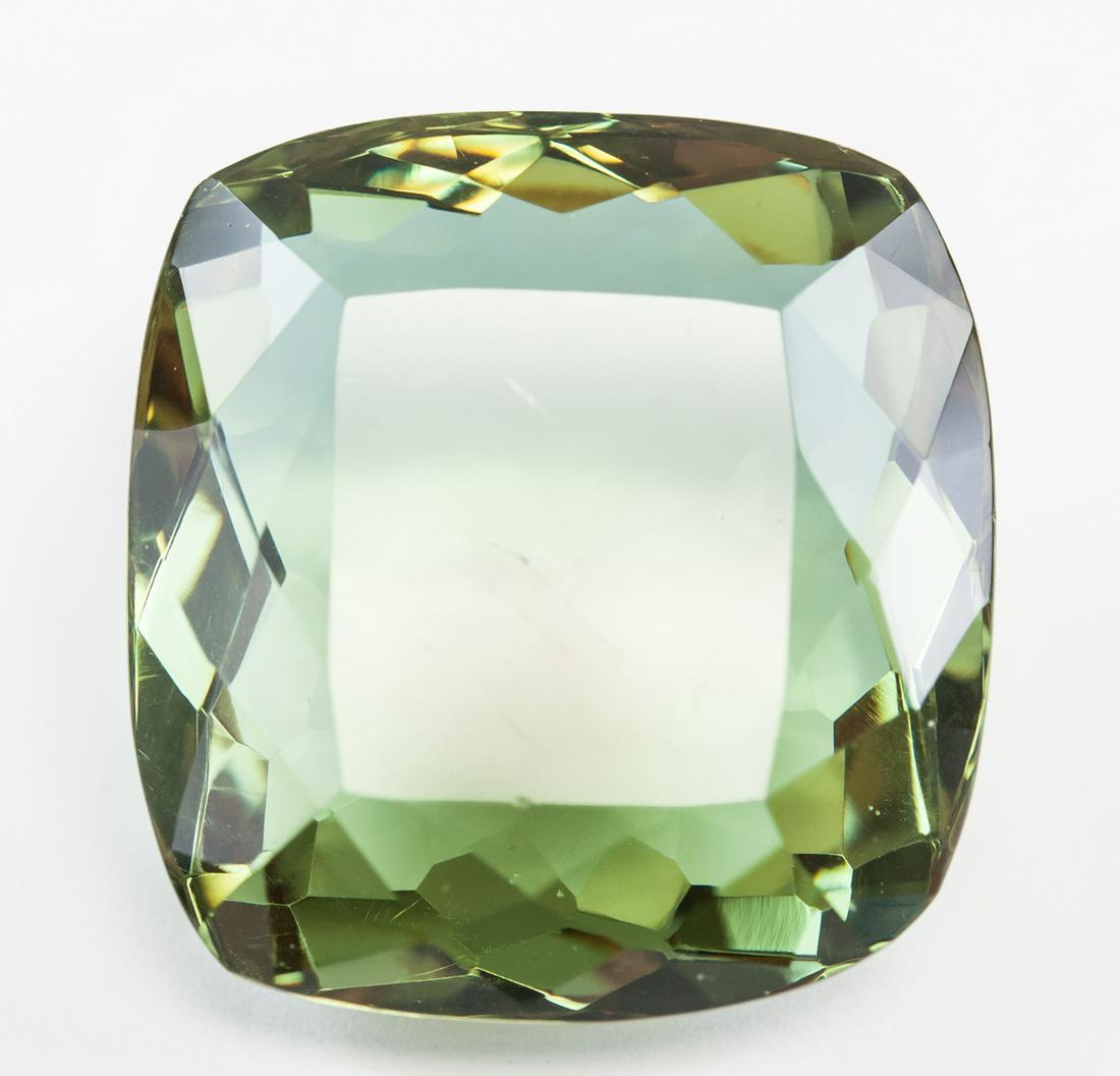 84.45ct Cushion Cut Brown to Green Alexandrite GGL: One (1) 84.45 ct cushion cut brown to green alexandrite. Origin: Brazil. Accompanied with GGL certificate. 27.78 x 25.80 x 16.46 mm.