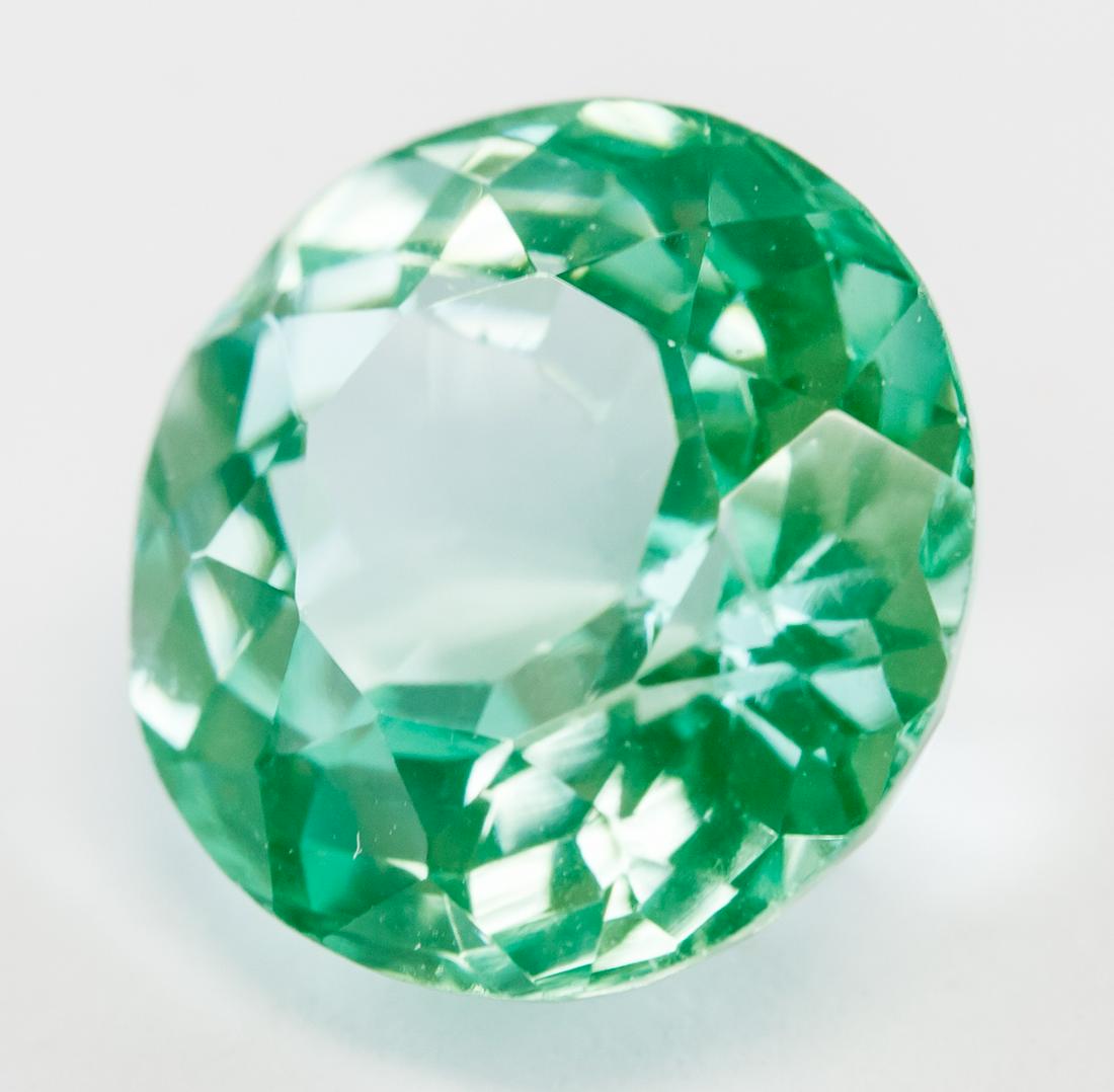 5.95ct Round Cut Green Natural Amblygonite GGL: One (1) 5.95 ct round cut light green natural amblygonite. Origin: Burma. Accompanied with GGL certificate. 10.75 x 10.60 x 6.83 mm.