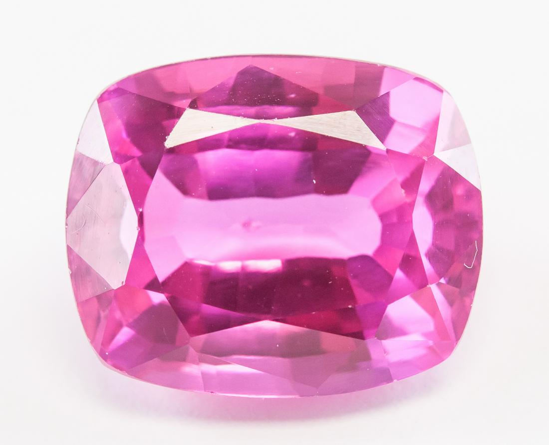 14.60ct Cushion Cut Pink Natural Danburite GGL: One (1) 14.60 ct cushion cut pink natural danburite. Origin: Mexico. Accompanied with GGL certificate. 14.35 x 11.85 x 8.25 mm.