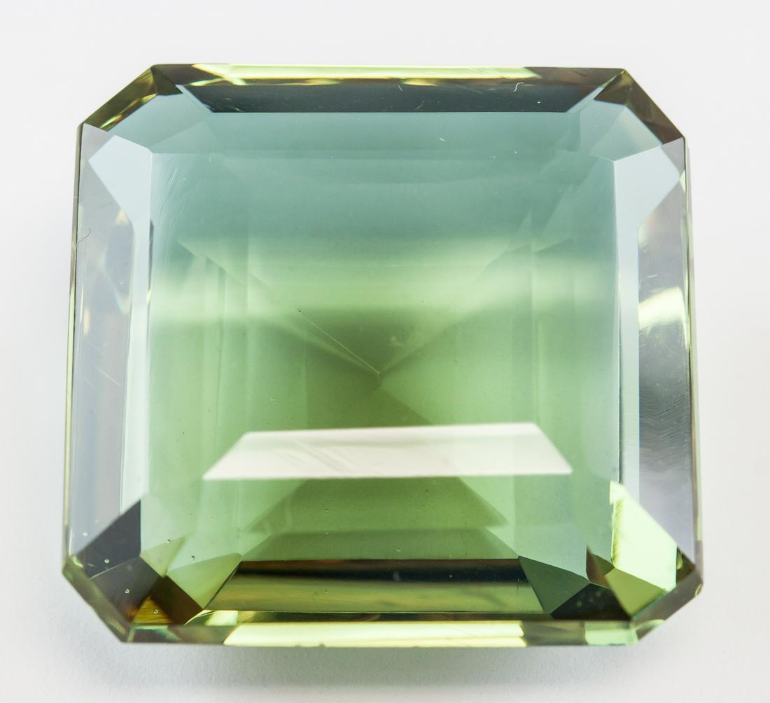 91.45ct Emerald Cut Brown to Green Alexandrite GGL: One (1) 91.45 ct emerald cut brown to green alexandrite. Origin: Brazil. 27.97 x 27.70 x 14.08 mm. Accompanied with GGL certificate.