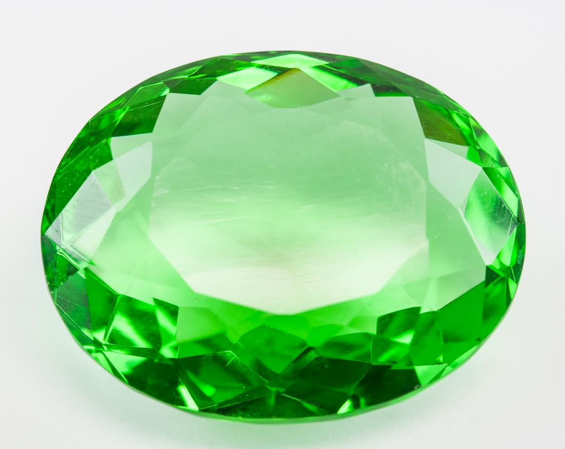 90.45ct Oval Cut Green Peridot GGL: One (1) 90.45 ct oval cut green peridot. Origin: Brazil. Accompanied with GGL certificate. 34.40 x 22.40 x 15.60 mm.