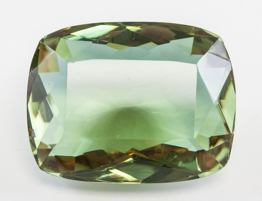 85.55ct Cushion Cut Green Natural Alexandrite GGL: One (1) 85.55 ct cushion cut brown to green natural alexandrite. Origin: Brazil. Accompanied with GGL certificate. 30.84 x 23.93 x 15.07 mm.