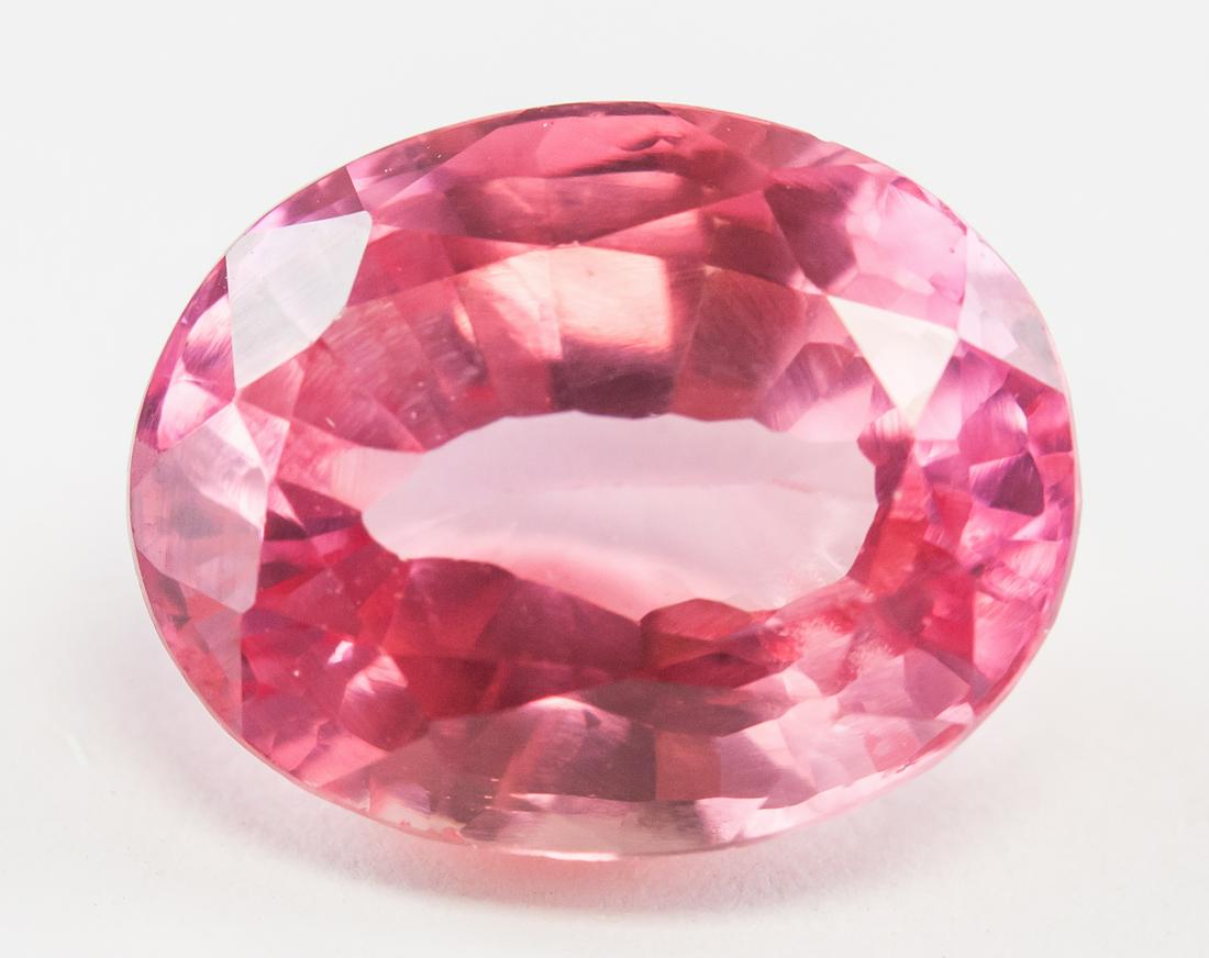 7.40ct Oval Cut Pink Natural Spinel GGL: One (1) 7.40 ct oval cut pink natural spinel. Origin: Sri Lanka. Accompanied by GGL certificate. 12.38 x 9.63 x 6.66 mm.